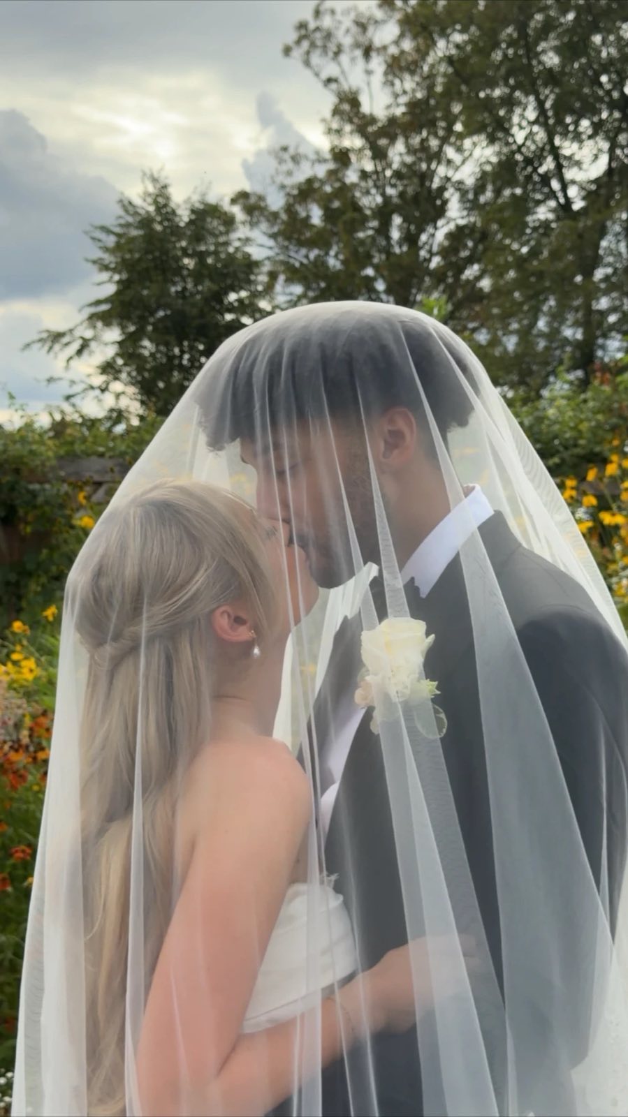 Bride and groom kissing beneath her veil, captured by a London wedding content creator