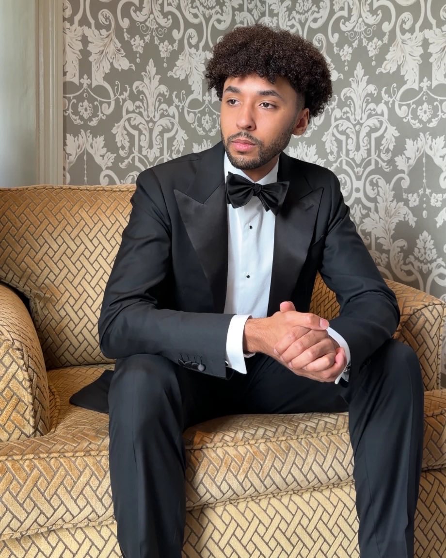 Groom in a black tie tuxedo waiting before the ceremony